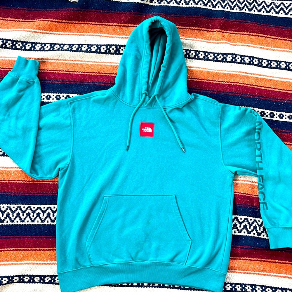 The North Face men’s hooded sweatshirt size medium Teal with a red patch